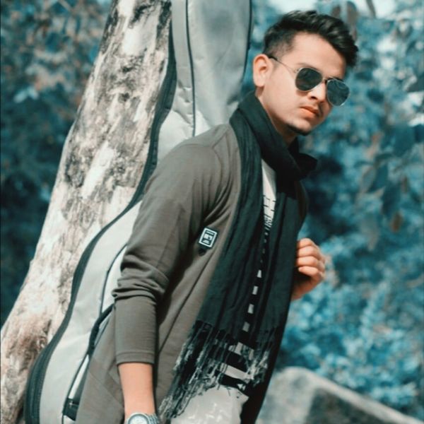 young adult, one person, fashion, sunglasses, glasses, standing, young men, tree trunk, trunk, tree, portrait, day, looking at camera, focus on foreground, casual clothing, waist up, looking, outdoors