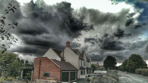 Houses against cloudy sky