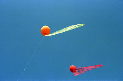 Close-up of red flag against blue sky