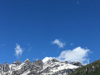 Low angle view of mountain against blue sky