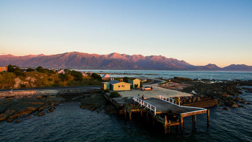 Scenic view of lake and mountains against clear sky