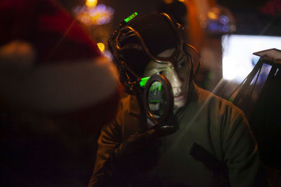 Portrait of man driving car at night