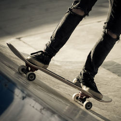 Low section of man skateboarding on skateboard