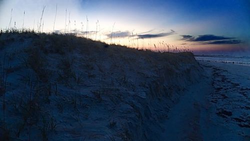 Scenic view of beach against sky during winter