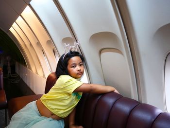 Portrait of young woman in airplane