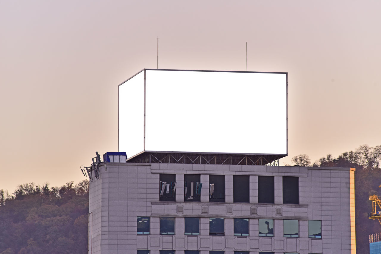 LOW ANGLE VIEW OF BUILDING AGAINST SKY DURING SUNSET