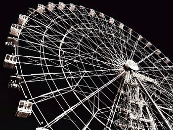 Low angle view of ferris wheel against sky