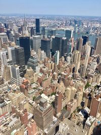 Aerial view of modern buildings in city against sky