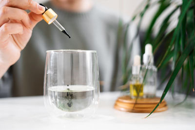 Cropped hand of woman working on table