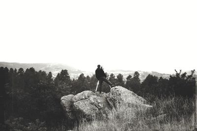 Silhouette of horse on landscape against clear sky