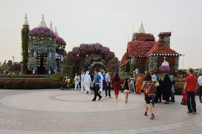 People walking in temple against sky