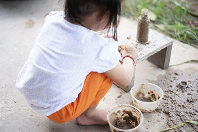 High angle view of boy playing with straw