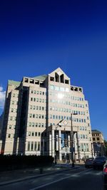 Low angle view of buildings against clear blue sky