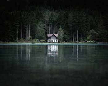 Building by lake against trees