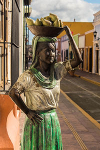 Statue standing by sculpture