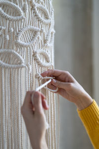 Cropped image of woman doing macrame