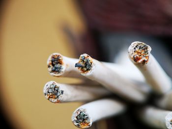 Close-up of cigarette smoking on wood