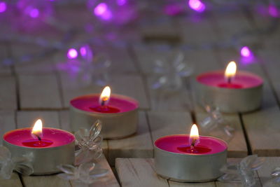 Close-up of illuminated candles on table