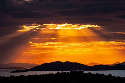 Scenic view of silhouette mountains against sky during sunset, murter, croatia