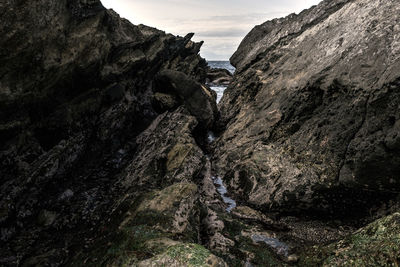 Low angle view of rock formation against sky