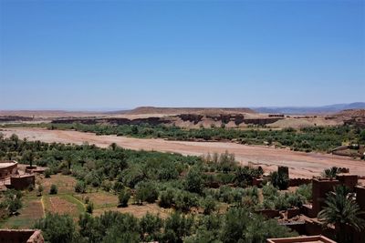 Scenic view of desert against clear blue sky