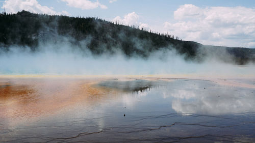 Scenic view of hot spring against mountain