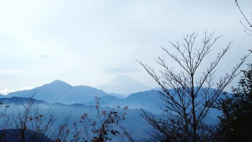 Scenic view of mountains against cloudy sky