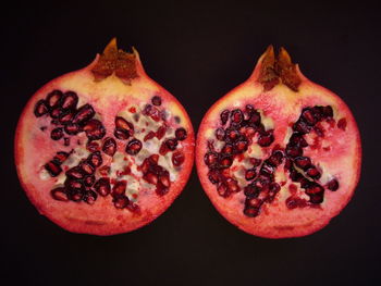 Close-up of red fruit over black background