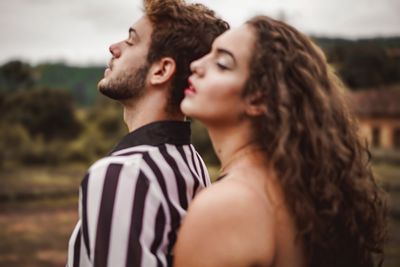 Portrait of young couple kissing outdoors