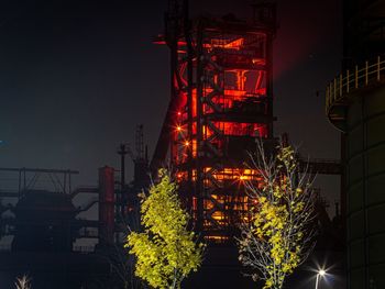 Low angle view of illuminated building against sky at night