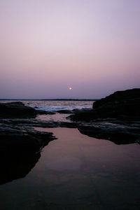 Scenic view of sea against clear sky during sunset