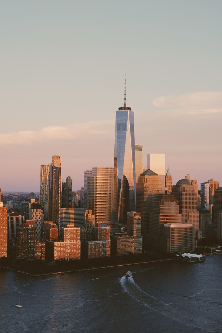 VIEW OF BUILDINGS IN CITY AGAINST SKY DURING SUNRISE