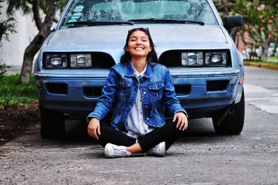 Side view of a smiling woman sitting in car