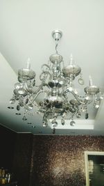 Illuminated chandelier hanging from ceiling