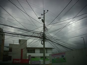 Low angle view of electricity pylon against sky