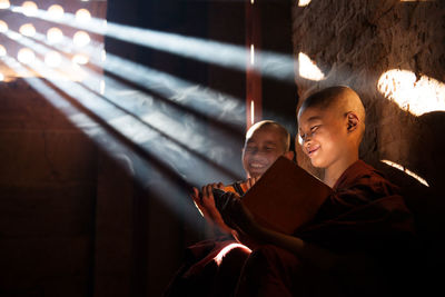 Happy monks reading book