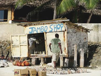 Rear view of man standing by building