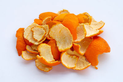 Close-up of orange fruit against white background