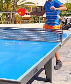 Rear view of boy standing by swimming pool