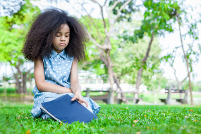 Young woman sitting on field