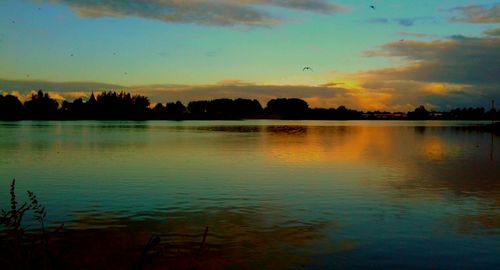 Scenic view of lake at sunset