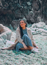 Woman sitting on rock