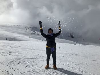 Full length of man standing on snow covered landscape