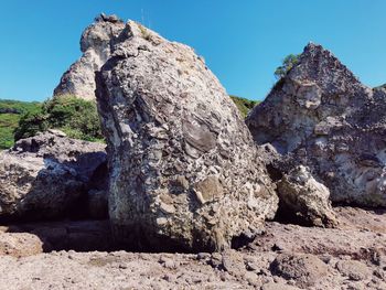 Low angle view of rock formations against sky