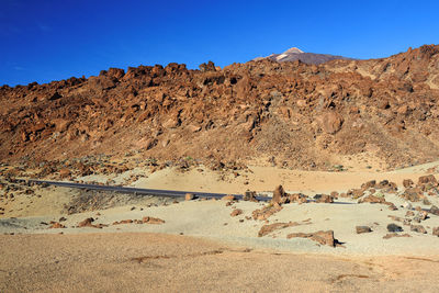 Scenic view of rock formations against clear blue sky at teide national park