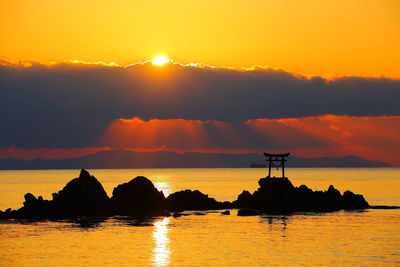 Offshore torii and sunrise
