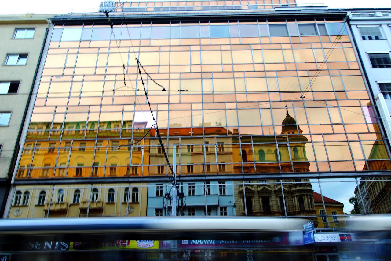 LOW ANGLE VIEW OF BUILDINGS AGAINST TRAIN IN CITY