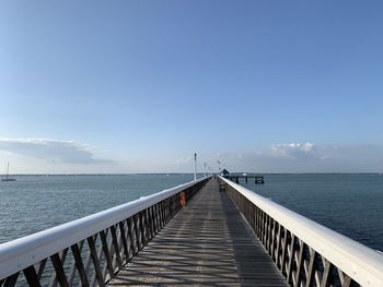 Pier over sea against sky