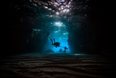 Scuba divers swimming in sea