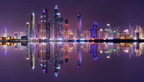 Panoramic view of illuminated buildings against sky at night